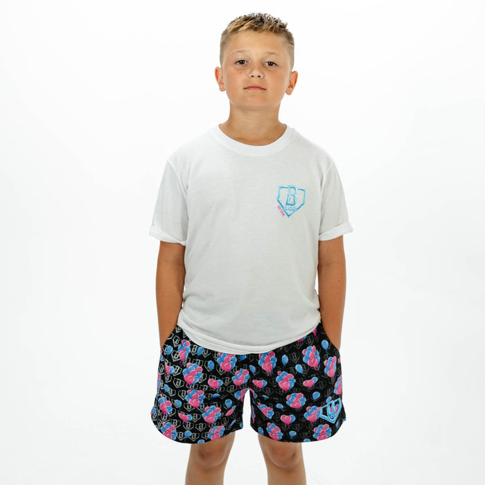 Youth model wearing blue youth shorts with "10 Year Anniversary" design